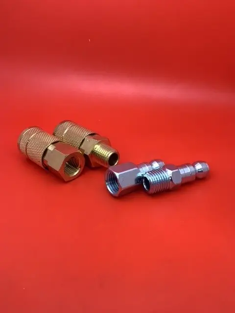 A pair of brass couplings and an aluminum connector.