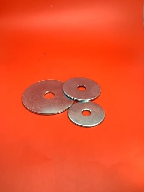 A group of three metal washers on top of a table.