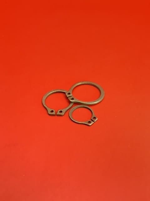 A pair of metal rings on top of a red surface.