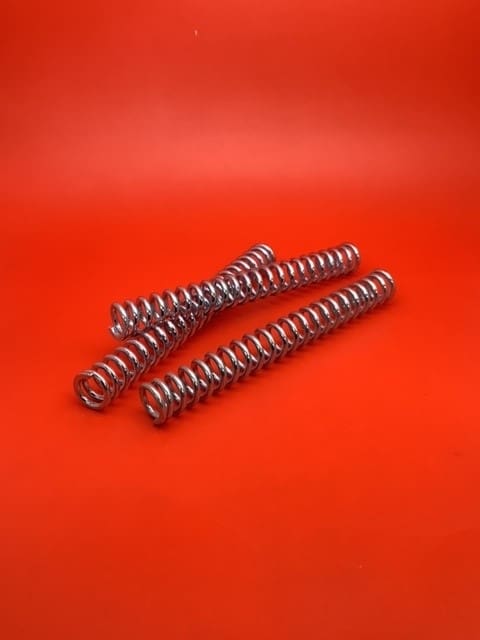 A red table with three springs on it