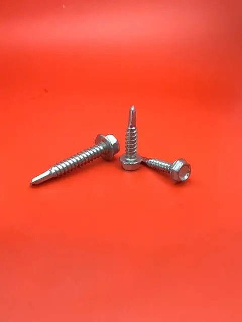 A close up of some metal screws on top of a table