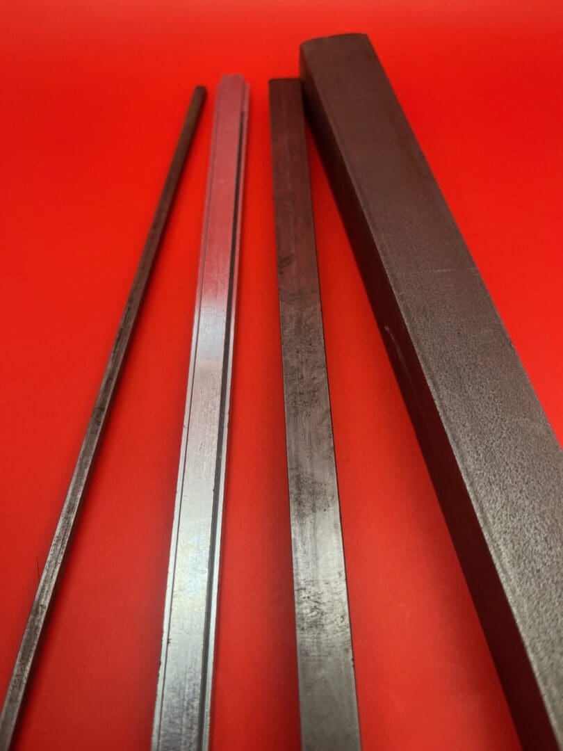 A red table with four different types of metal