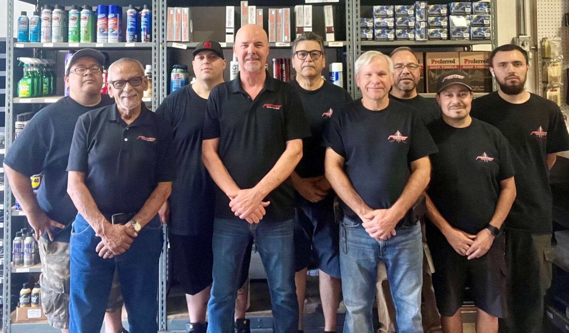 A group of men standing in front of shelves.