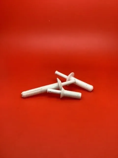 A red table with three white toothbrushes on it