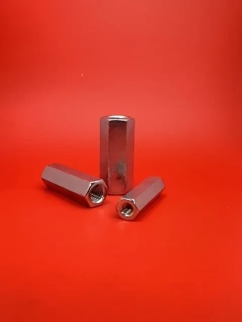 A couple of metal nuts sitting on top of a red table.