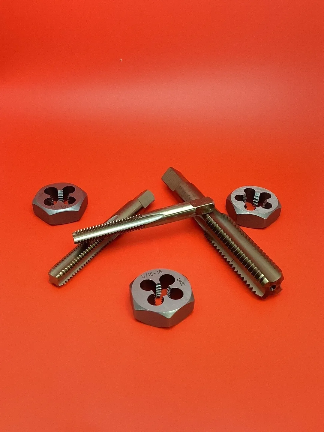 A set of four different sizes of die and two wrenches.