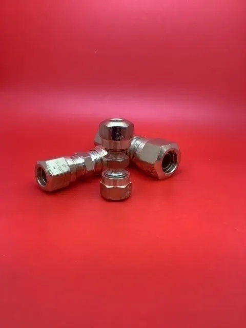 A group of three metal nuts sitting on top of a red table.