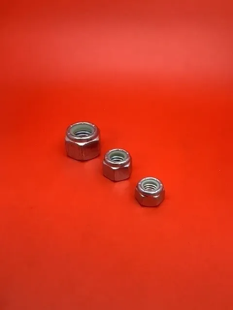 Three nuts are shown on a red surface.