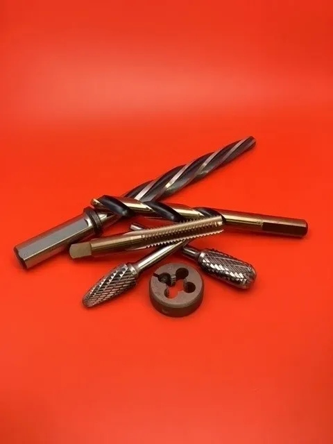 A group of drill bits and an individual tool.