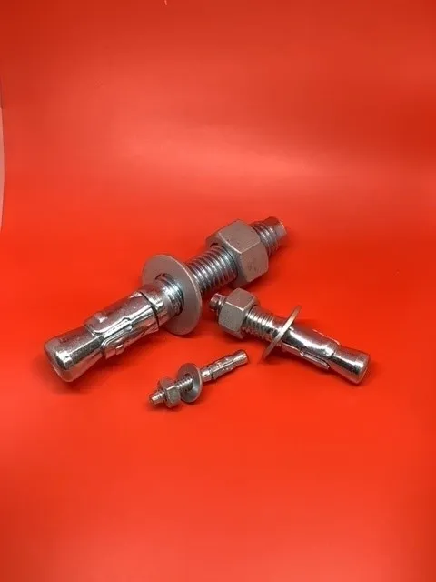 A close up of some nuts and bolts on a red background